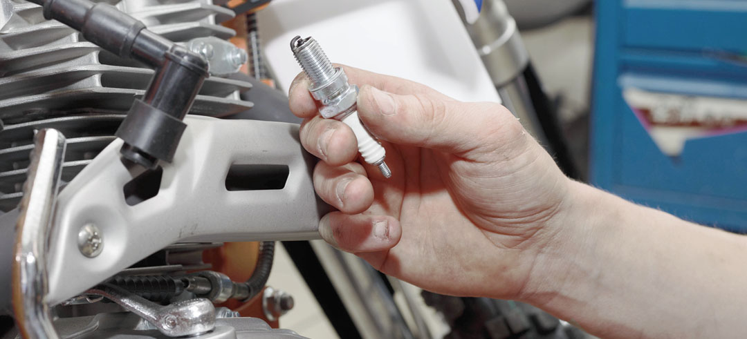 Persona cambiando una pieza de moto en un taller mecánico